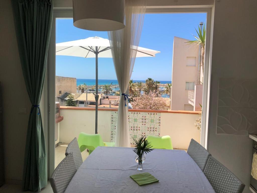 mesa de comedor con vistas al océano en Le Muse casa vacanze en Scoglitti