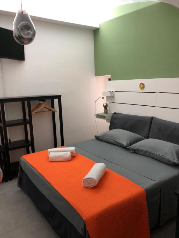 a bedroom with a bed with two towels on it at La Casa di Orlando in Catania