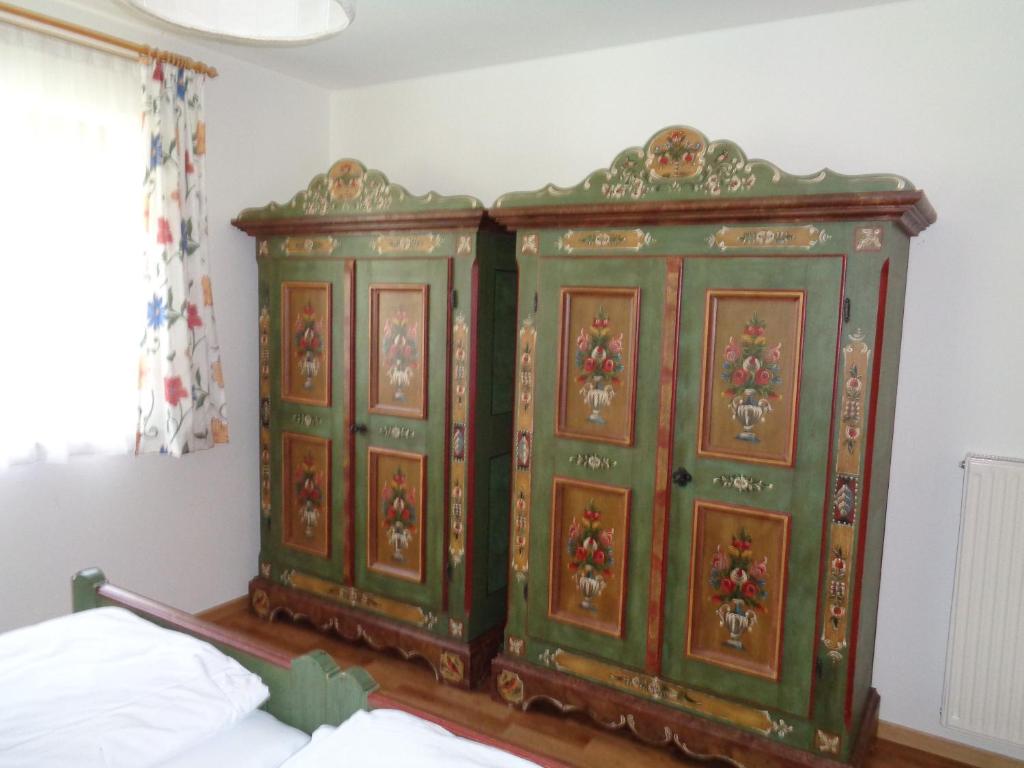 a pair of green cabinets in a bedroom at Althuberhof in Planca di Sopra