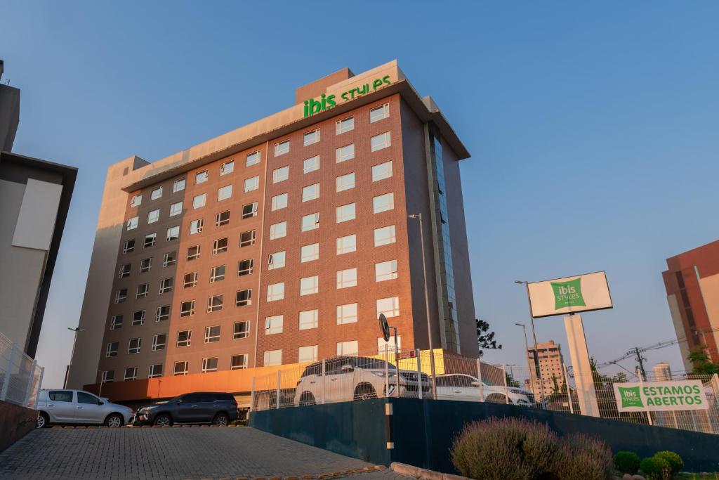 a hotel building with a sign on top of it at ibis Styles Curitiba Aeroporto in São José dos Pinhais