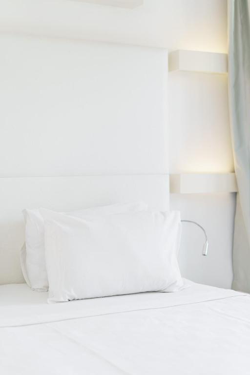 a bed with two pillows on it in a room at Costa Luvi Hotel Bodrum - All Inclusive in Gümbet