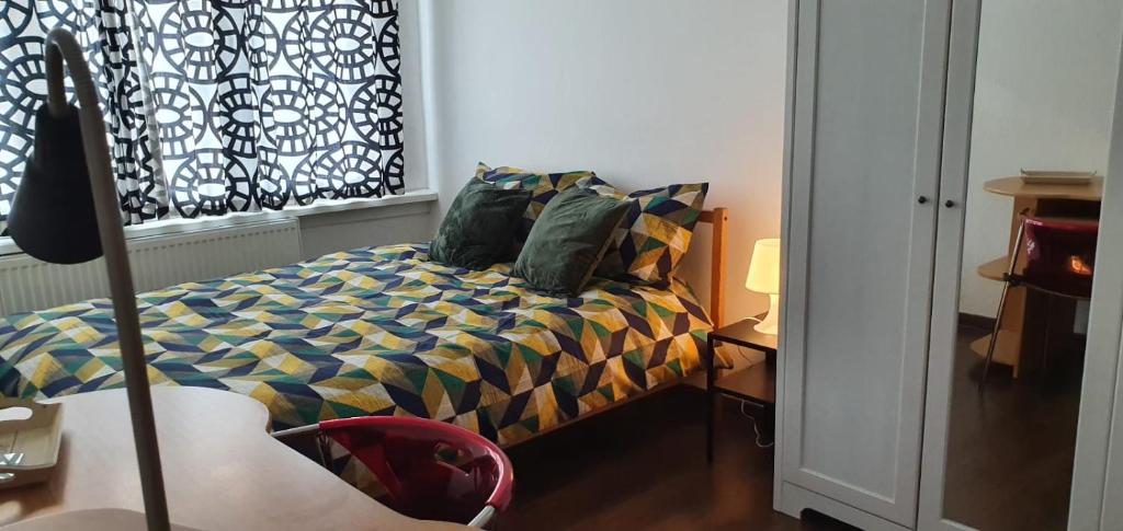 a bedroom with a bed and a window at COSY ROOM IN ANTWERPEN in Mortsel