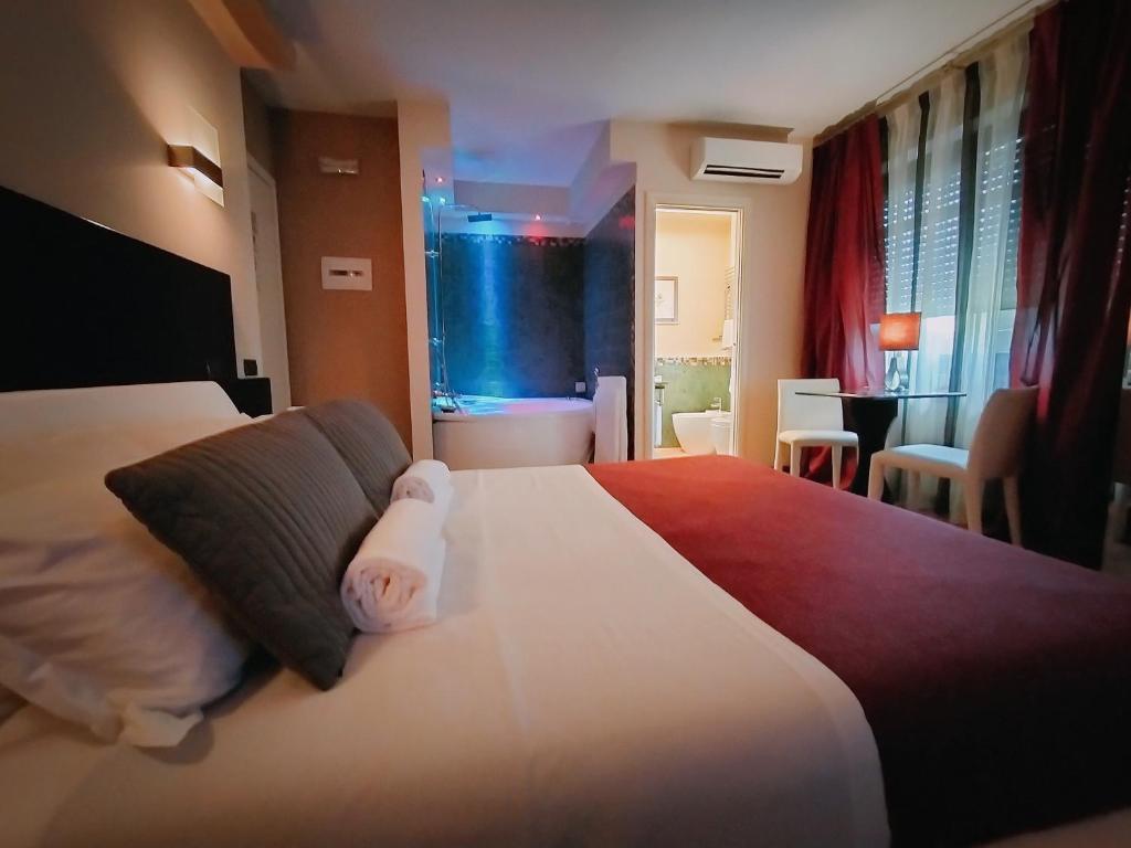 Postel nebo postele na pokoji v ubytování Hotel L' Orto degli Otelli
