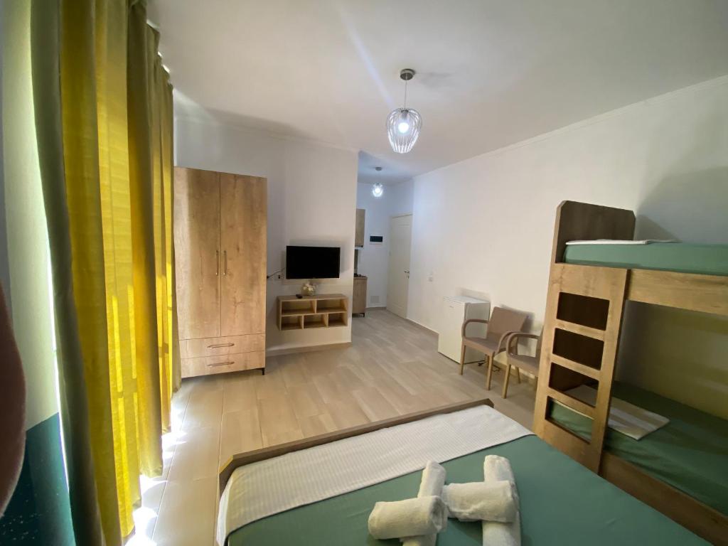 a bedroom with a bunk bed and a living room at Villa Luan Ksamil in Ksamil