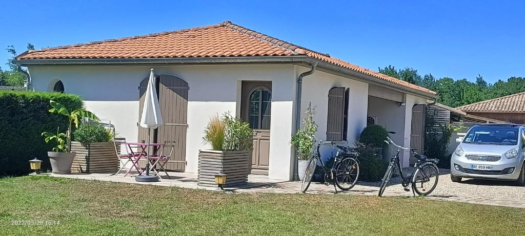 une maison avec deux vélos garés devant elle dans l'établissement Studio indépendant mios bourg, à Mios