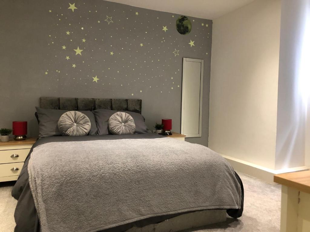 a bedroom with a bed with stars on the wall at 08 St Andrews in Lytham St Annes