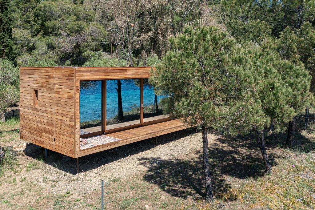 a small wooden house with a view of the water at iHouse Nea Skioni in Nea Skioni