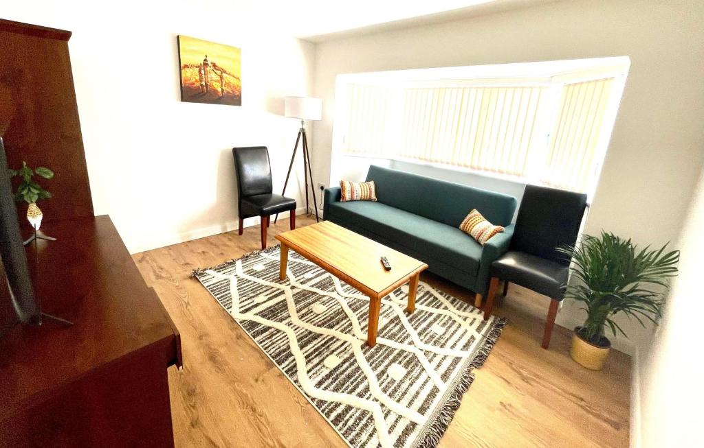 a living room with a couch and a table at Apartment in Oxfordshire in Sunningwell
