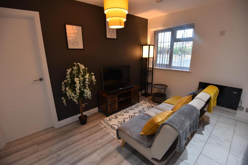 a living room with a couch and a television at Exclusive!! Newly Refurbished Speedwell Apartment near Bristol City Centre, Easton, Speedwell, sleeps up to 3 guests in Bristol