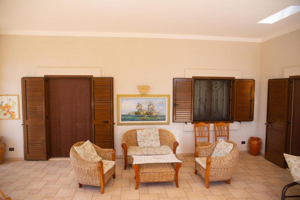 un soggiorno con sedie e tavolo di Villa Tonia a Fasano