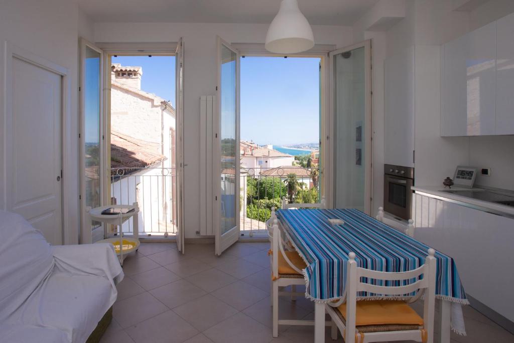 a room with a table and a kitchen with a view at N236 - Numana, bilocale vista mare nel cuore del paese in Numana