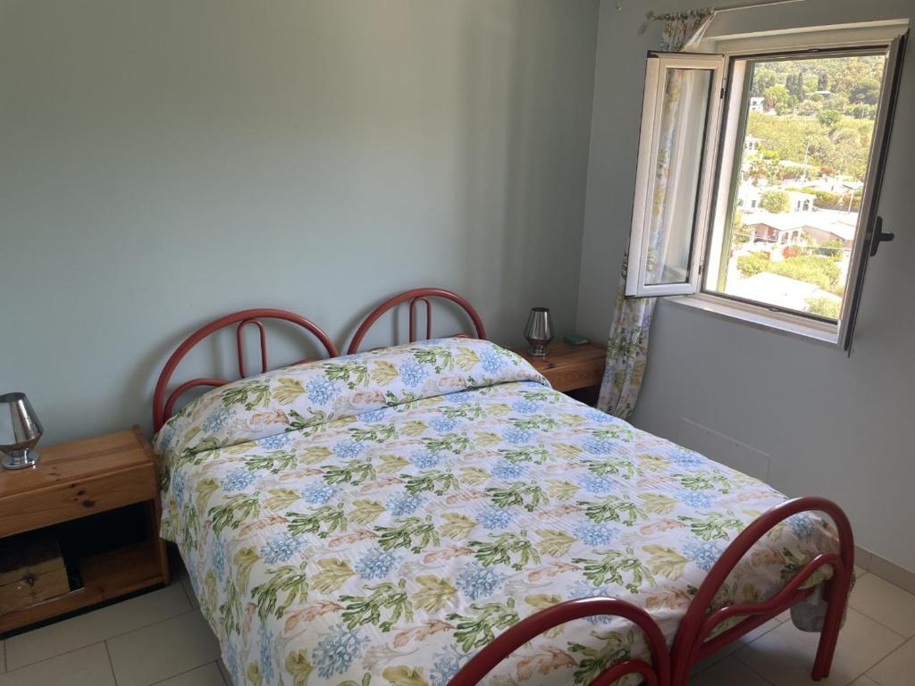 a bedroom with a bed with a quilt on it at Capovaticano - Unique SEA VIEW - Villa Renaissance in Santa Maria