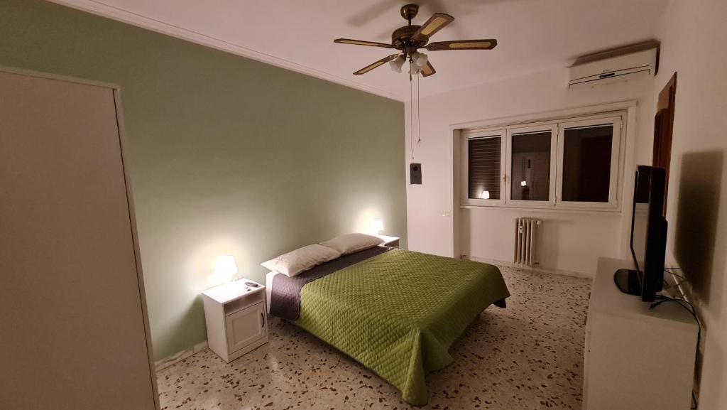 a bedroom with a bed and a ceiling fan at Danielle B&B in Rome