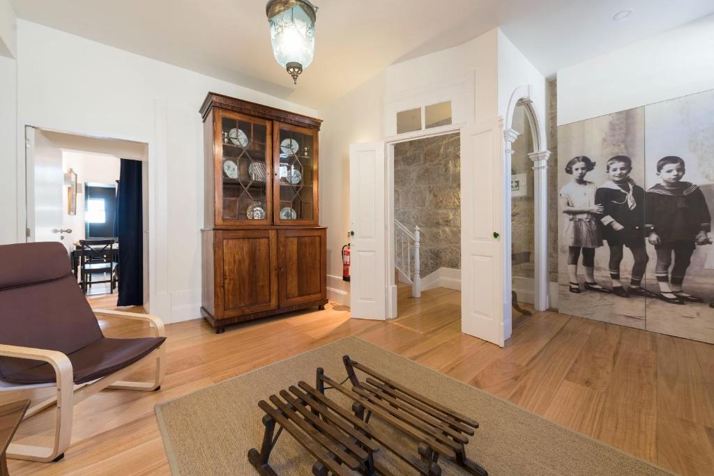 a living room with a couch and a chair at Casa da Muralha in Porto