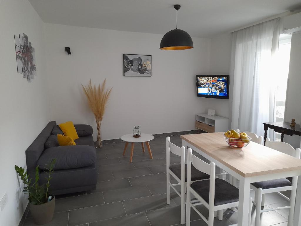a living room with a couch and a table at Apartman Mihaela in Rab