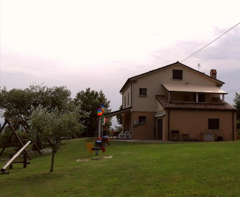 a house with a yard with a playground at Domus Mori in Orciano di Pesaro