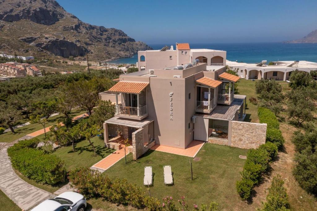 an aerial view of a house with the ocean in the background at Fedra Plakias in Plakias