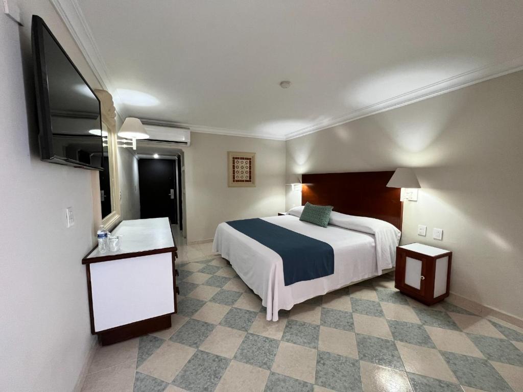 Postel nebo postele na pokoji v ubytování Hotel Sands Arenas
