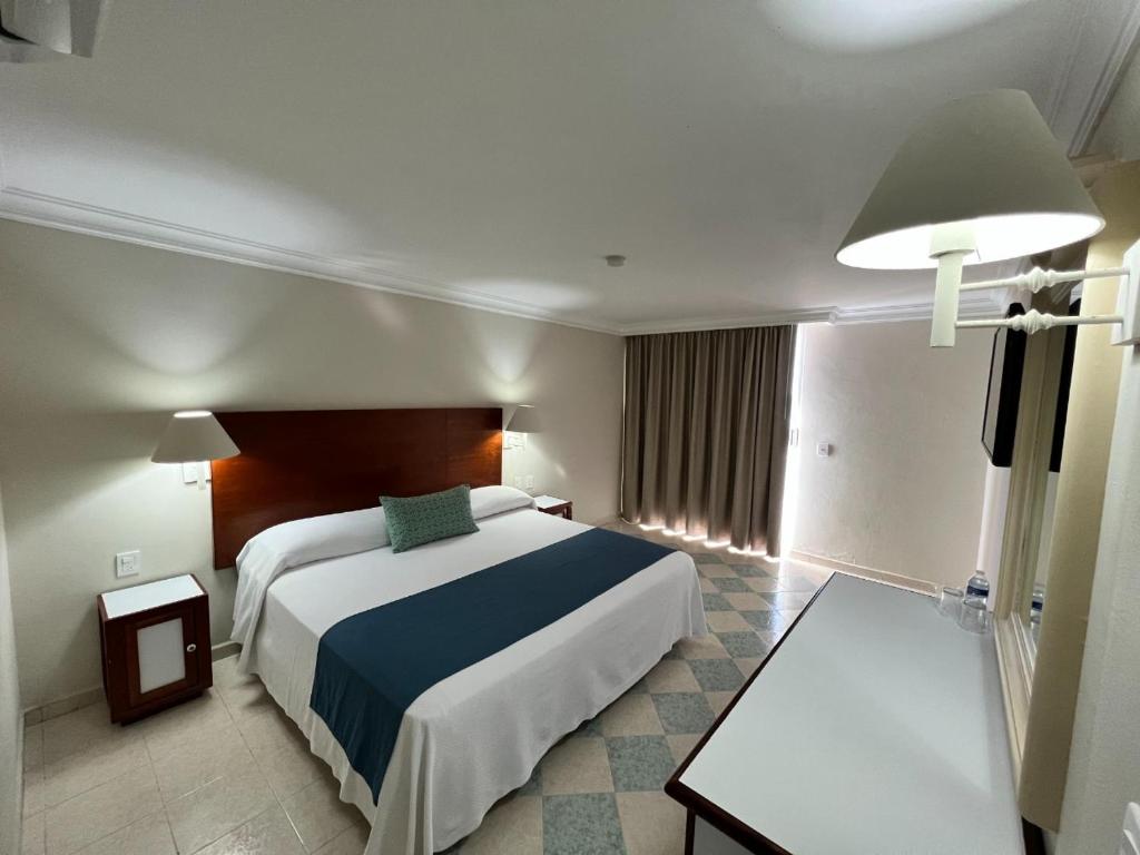 Postel nebo postele na pokoji v ubytování Hotel Sands Arenas