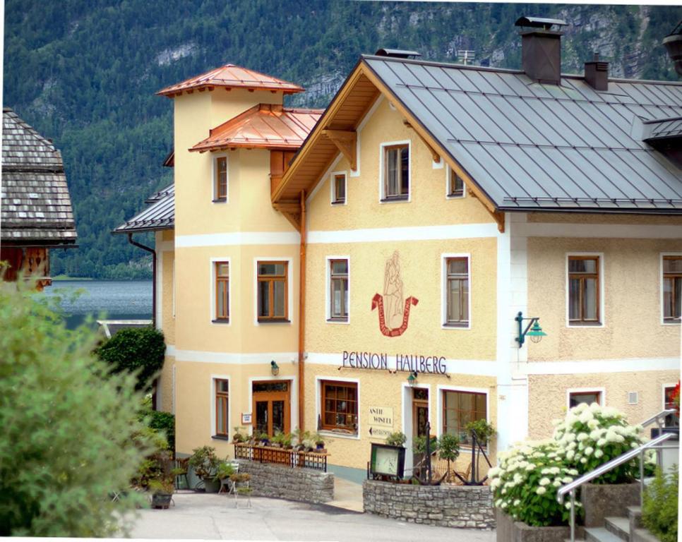 a large yellow building with a fish face on it at Pension Hallberg in Hallstatt