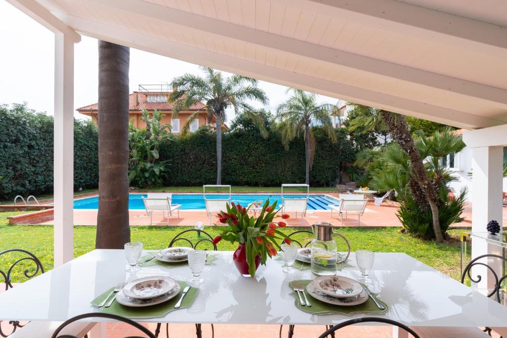 a white table with plates of food on it at Domus Orestea Luxury Suites in Palermo