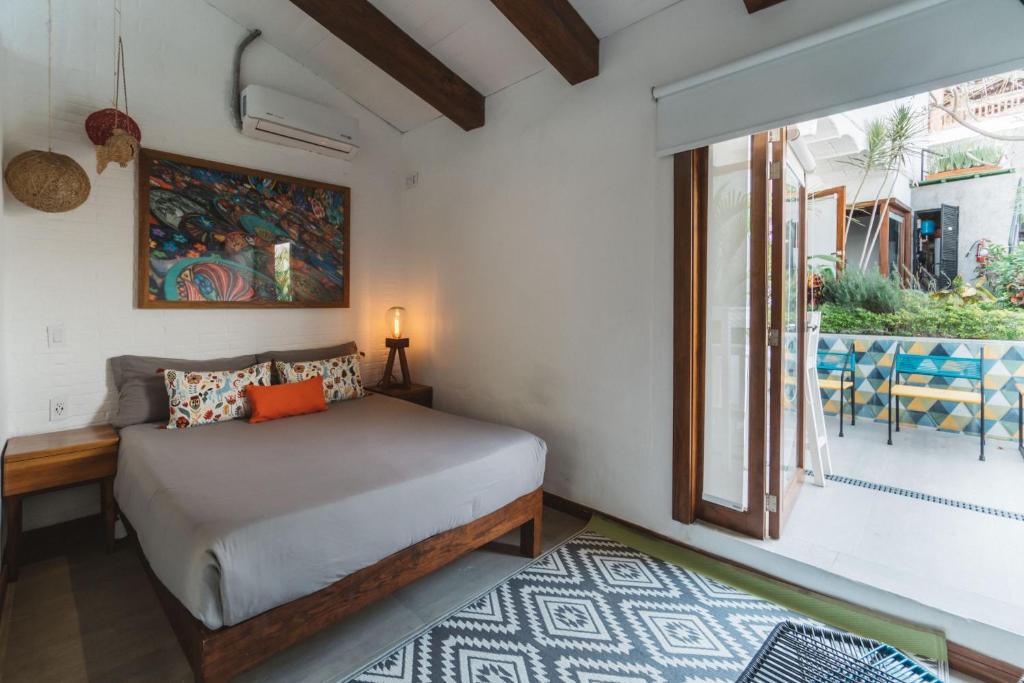 a bedroom with a bed and a window at Amaia Boutique Hotel in Sayulita