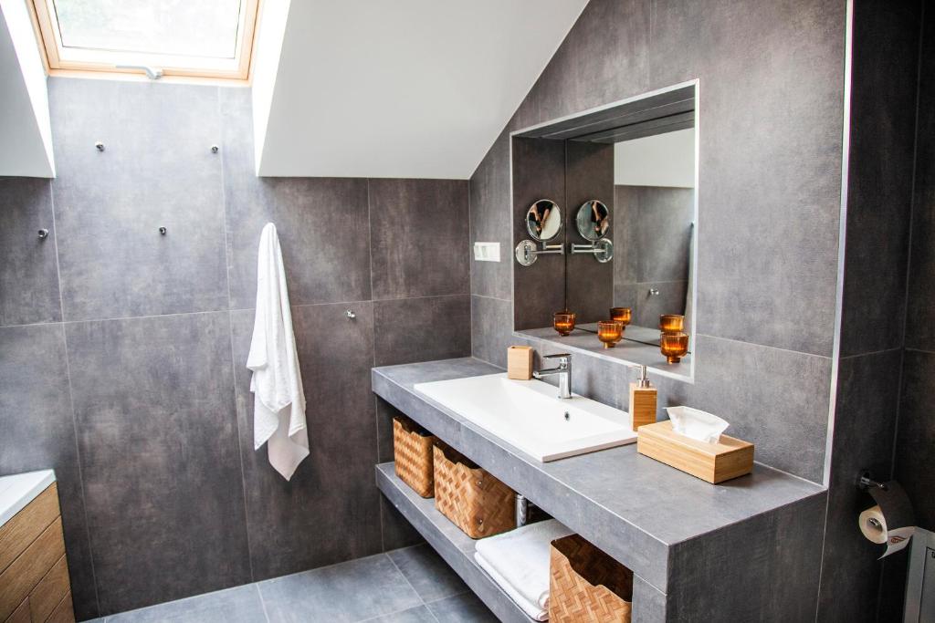 a bathroom with a sink and a mirror at BalaKing in Zamárdi