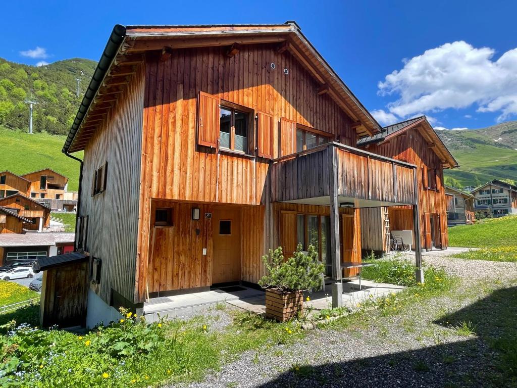 a wooden house with a barn at Ferienhaus Elisabeth - zentral, geräumig und familienfreundlich in Malbun