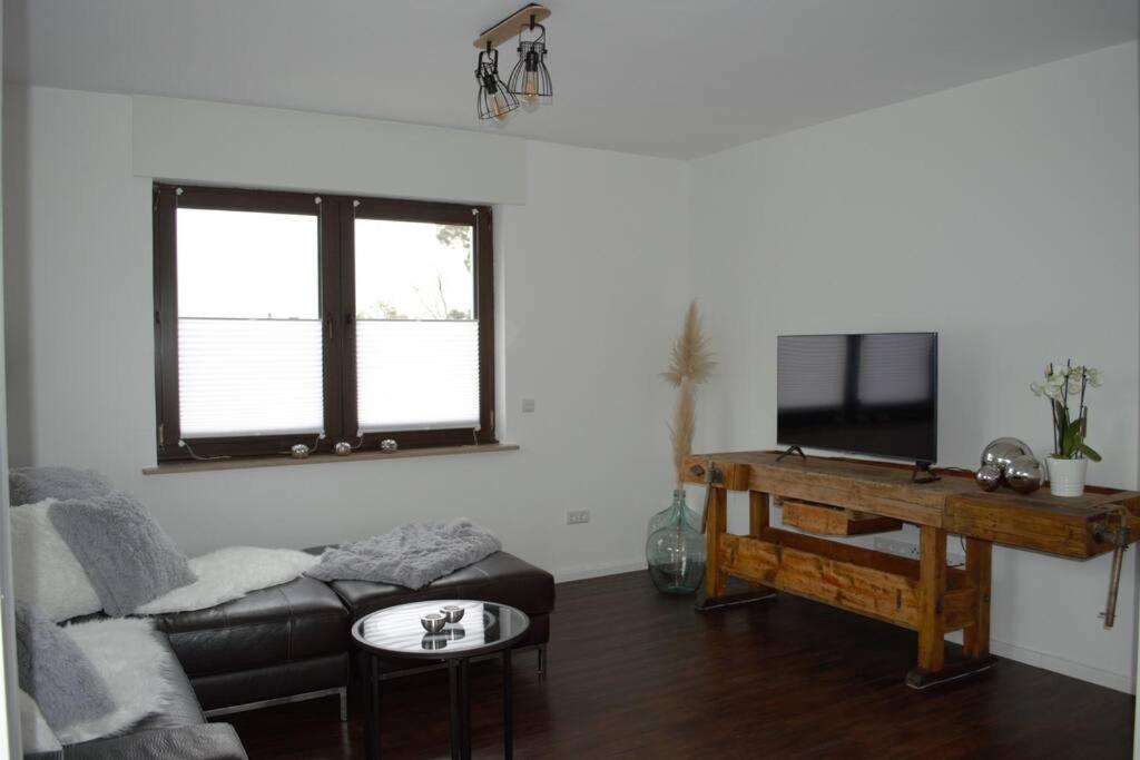 a living room with a couch and a table at Ferienhaus Esten's Eifelheimat Wehr Eifel in Wehr