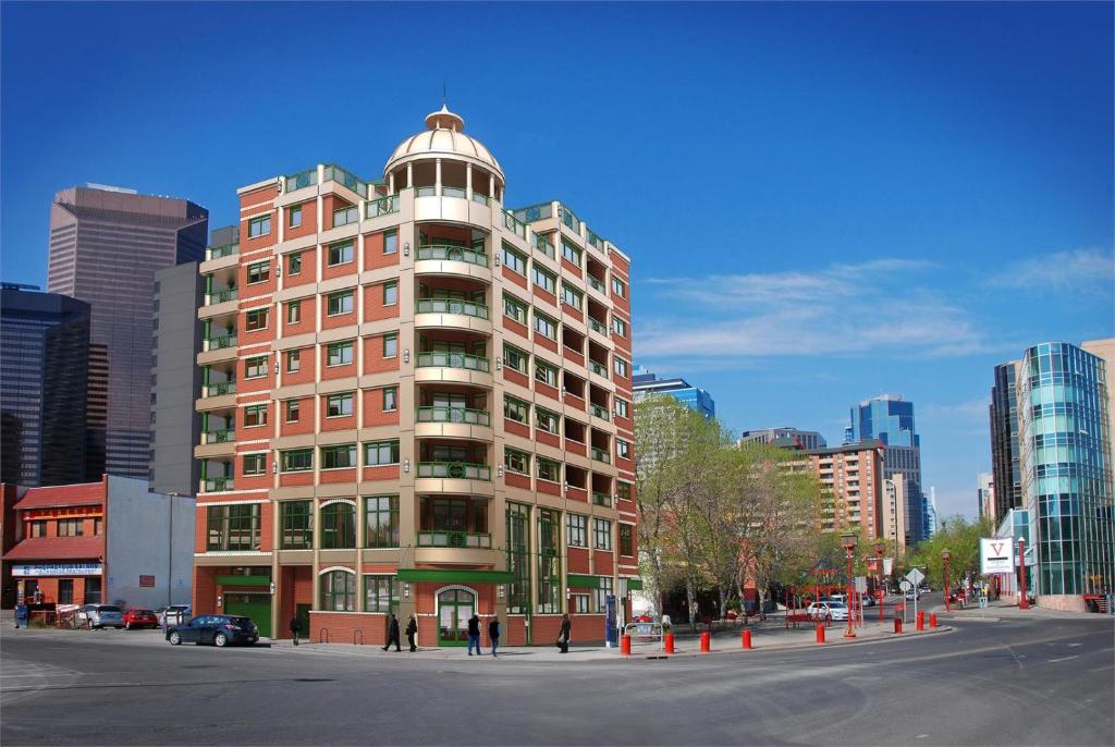 a tall red building with a dome on top of it at ELEMENT ON FIRST by Manna in Calgary