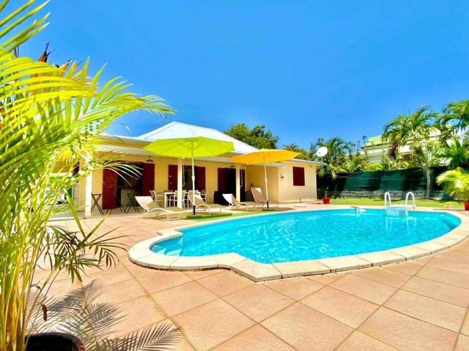 uma piscina em frente a uma casa em Villa Kajoline à Petit-Bourg em Petit-Bourg