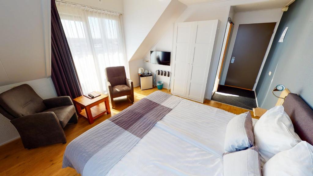 Postel nebo postele na pokoji v ubytování DuinHotel Texel