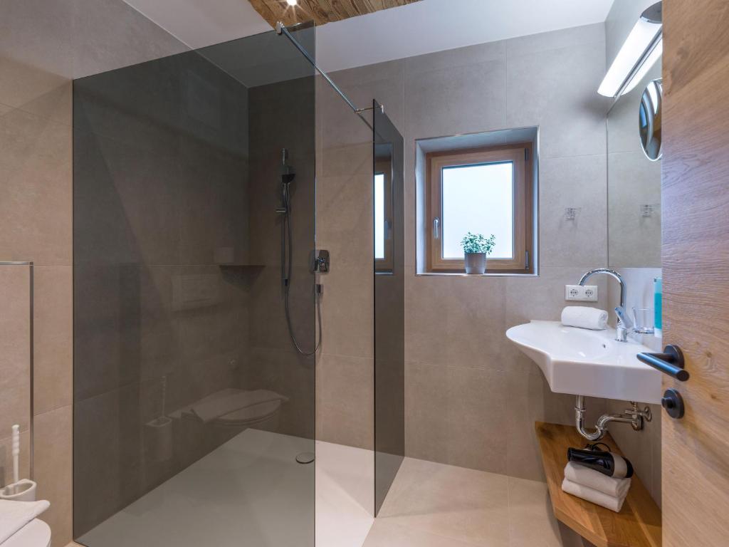 a bathroom with a shower and a sink at Appartements Schedererhaus in Going