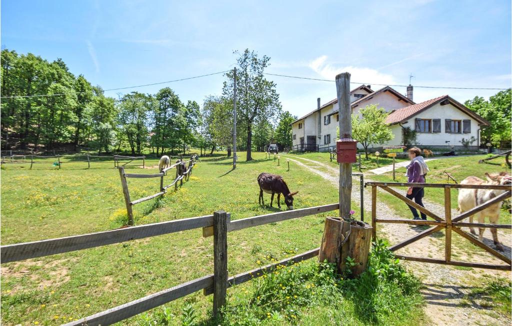 a group of animals in a field behind a fence at Amazing Home In Tiglieto With 4 Bedrooms in Tiglieto