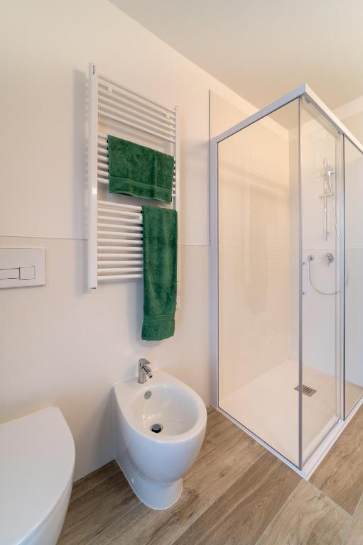 a white bathroom with a shower and a sink at Zero5.Zero5 in Lignano Sabbiadoro
