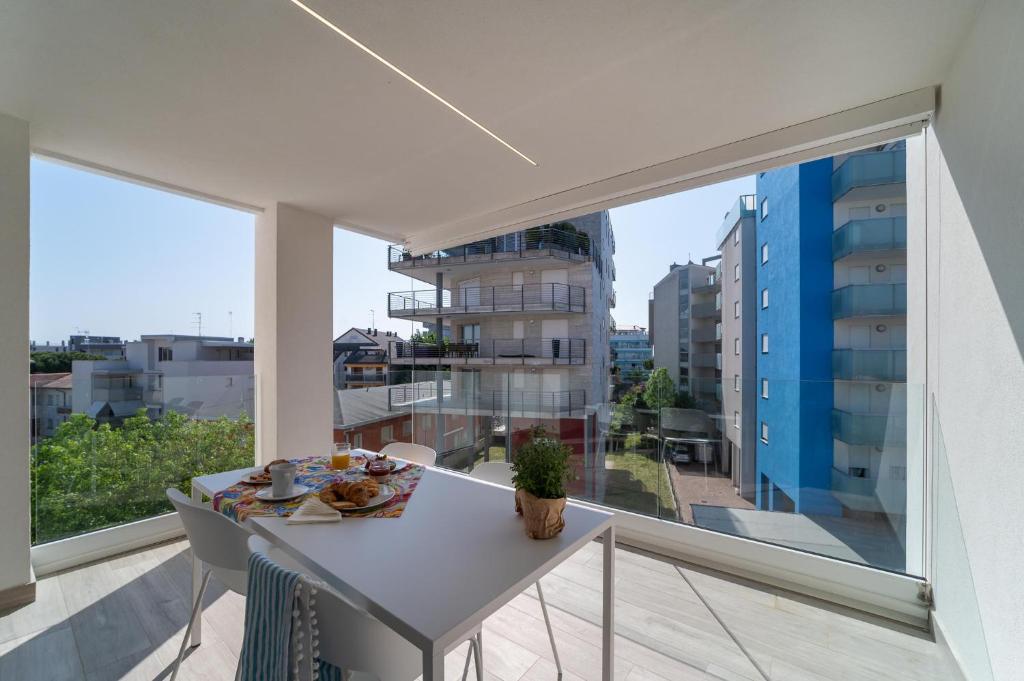 a balcony with a table with food on it at Zero5.Zero5 in Lignano Sabbiadoro