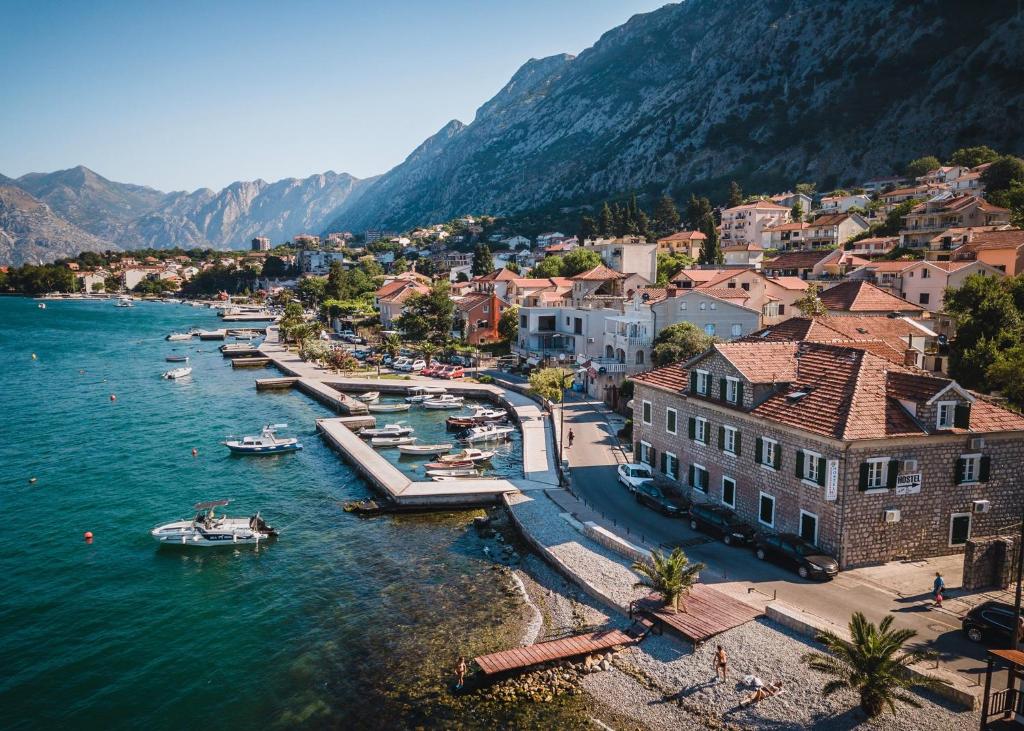 an aerial view of a town with boats in the water at Montenegro Hostel 4U in Kotor