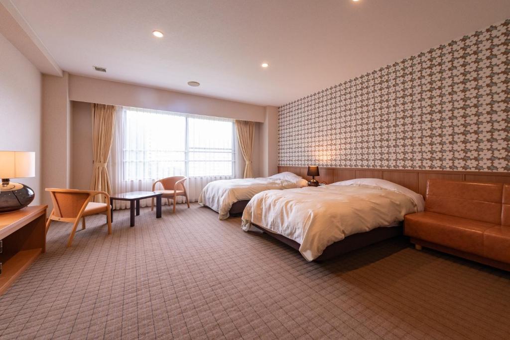 Postel nebo postele na pokoji v ubytování Yuzawa Toei Hotel