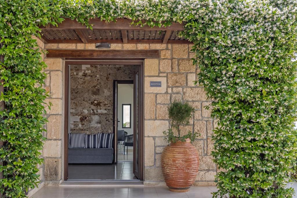 an entrance to a building with a large vase at Tramonto Suites in Xi