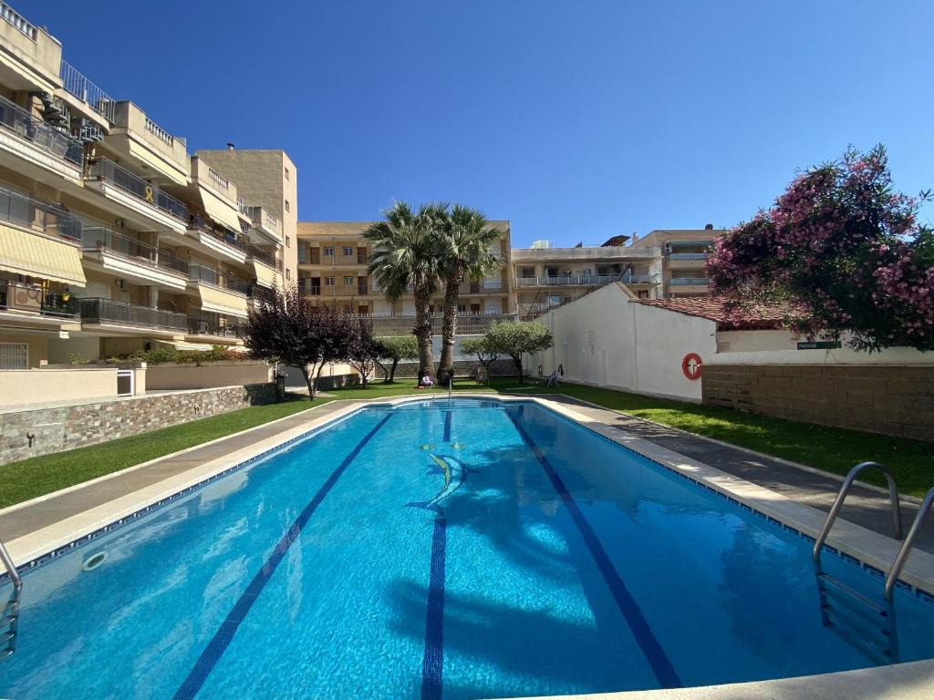 a swimming pool in the middle of a building at R128 Apartamento Camen in Calafell