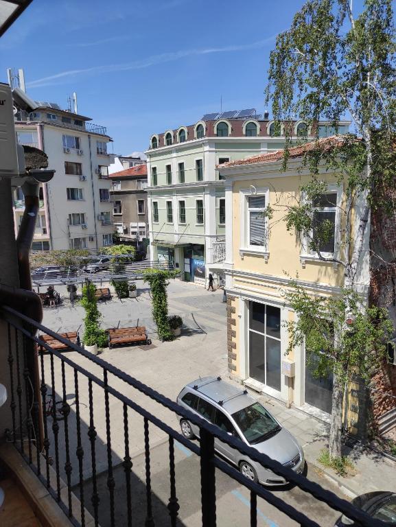 a balcony with a car parked on a street at ALEKS Top Center in Burgas