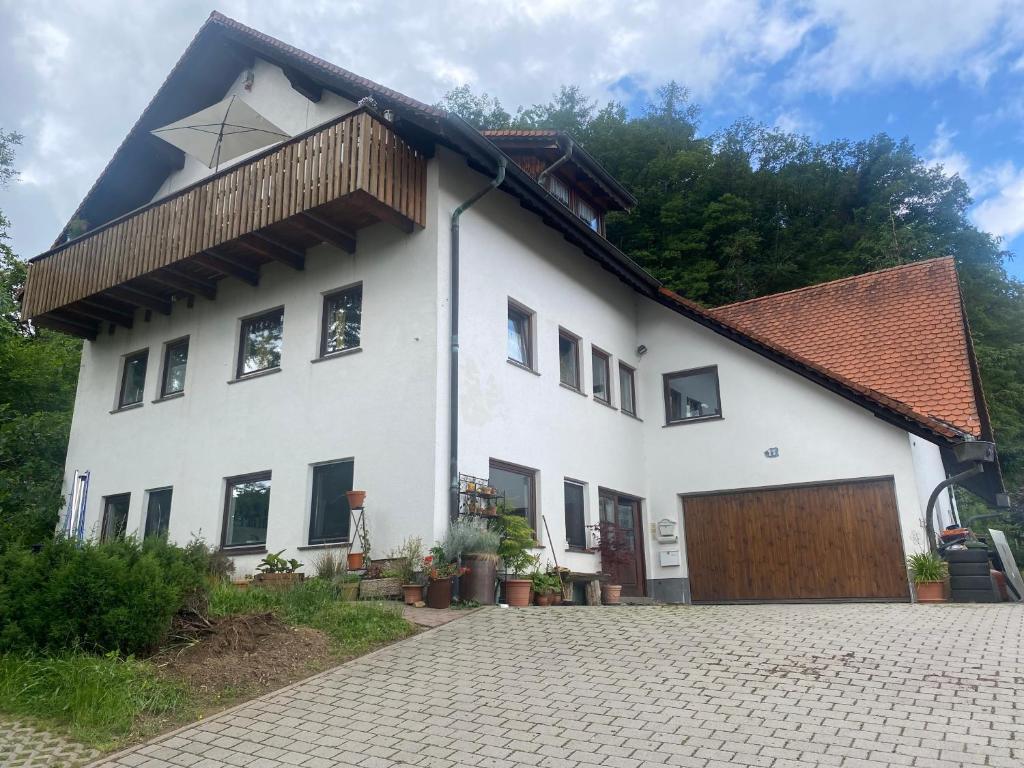 a white house with a brown roof at Haus Dreil in Ober-Abtsteinach