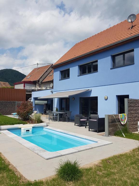 ein Haus mit einem Swimmingpool davor in der Unterkunft Gîte à la Source in Breitenbach