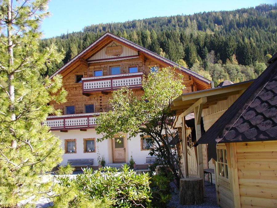 a large wooden house with a balcony on top of it at Chalet Auhof Flachau in Flachau
