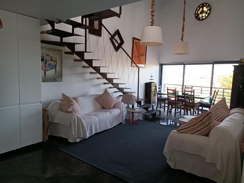 a living room with two couches and a staircase at CASA NAOS in Arrecife