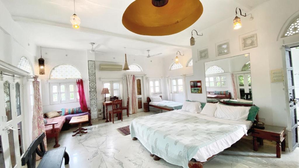 - une chambre avec un grand lit et un salon dans l'établissement Dia Homestay, à Pushkar