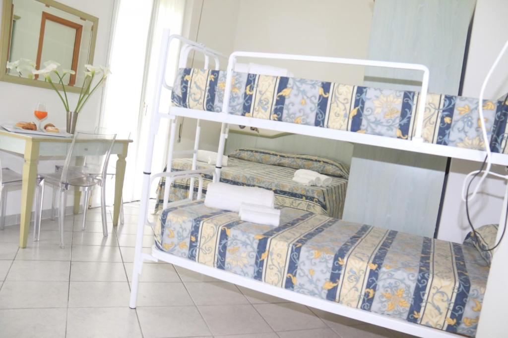 Postel nebo postele na pokoji v ubytování Hotel Ginevra e Residence