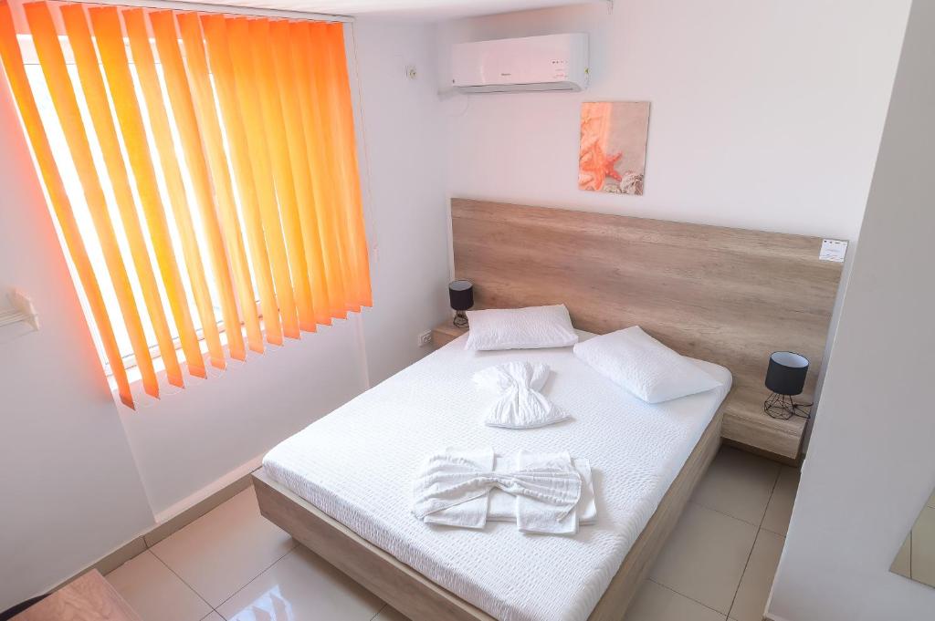 Postel nebo postele na pokoji v ubytování Hotel Proton K3