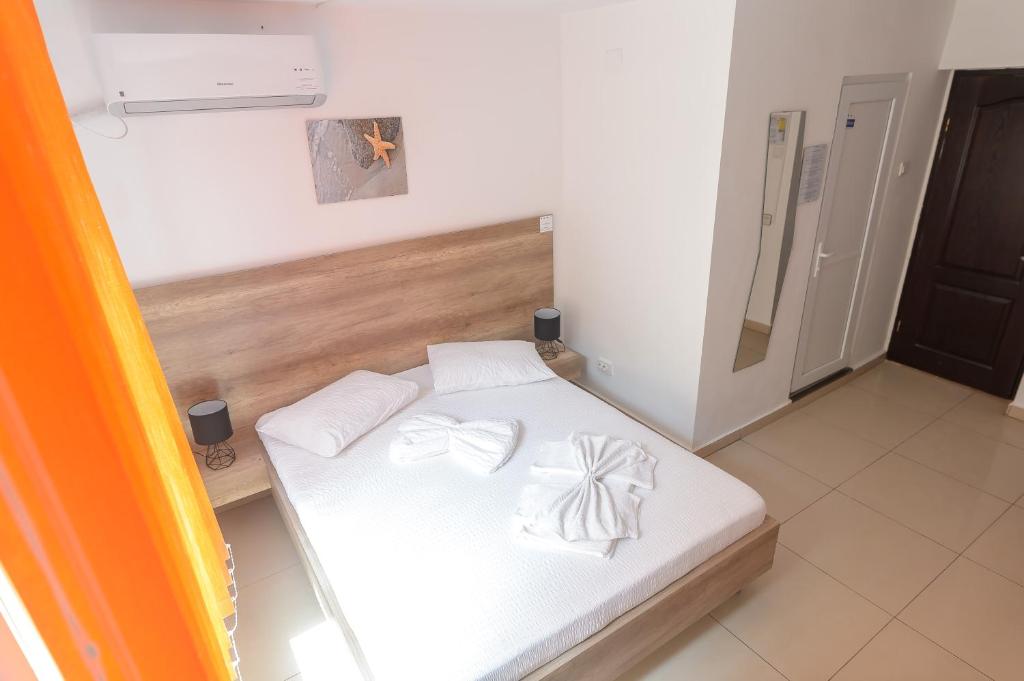 Postel nebo postele na pokoji v ubytování Hotel Proton K3