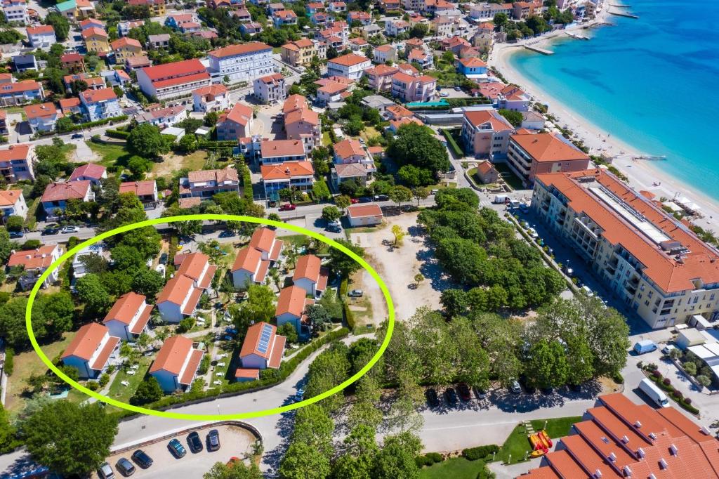 an aerial view of a resort with a yellow circle at Villas Corinthia in Baška